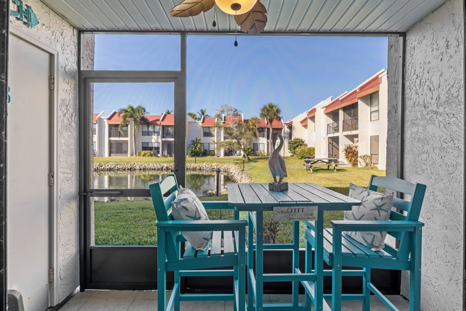 Screened-in lanai with new patio furniture with walk-out to pond