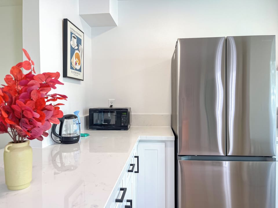 Hot water kettle, microwave and fridge
