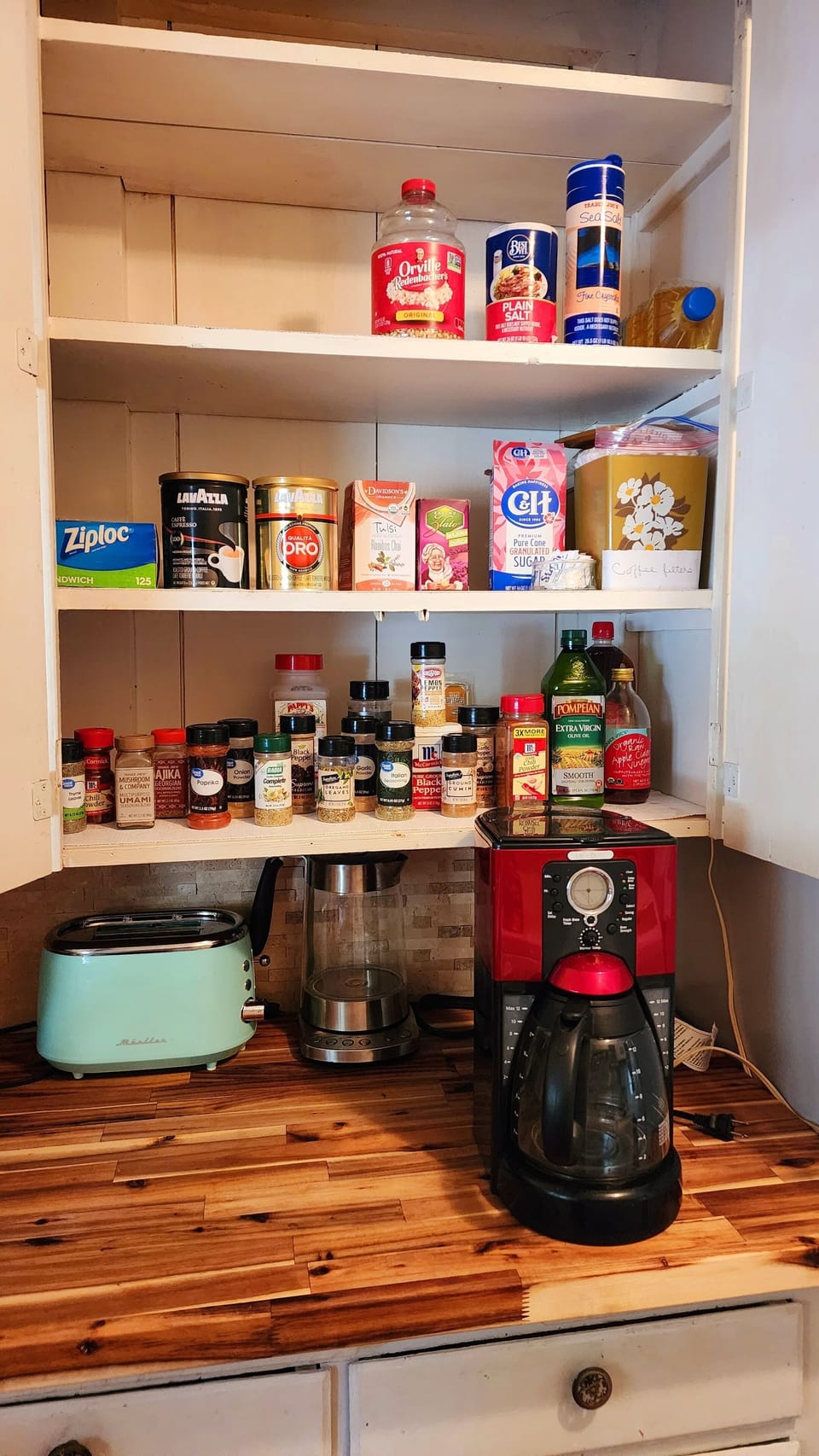 Fully stocked kitchen with coffee, tea, herbs, cooking oil 