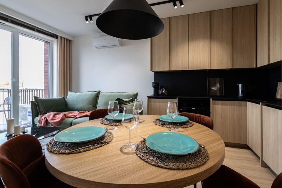 Dining table and large kitchen with wooden accents