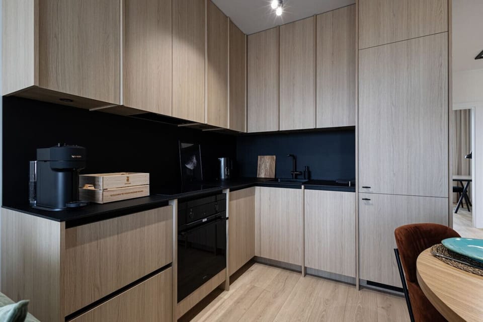 large kitchen with oven and induction hob and dishwasher