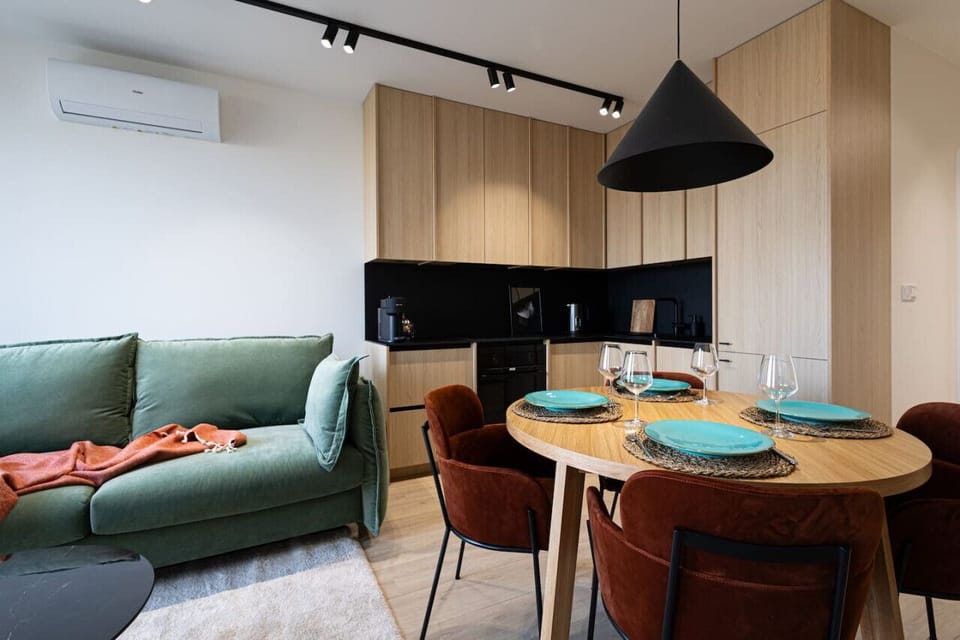 Dining table and large kitchen with wooden accents