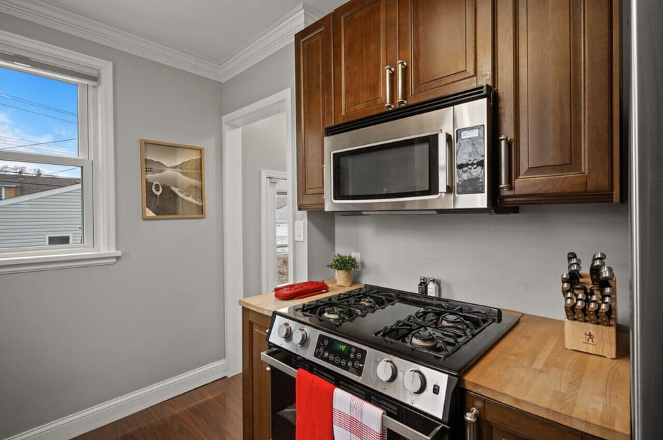 Kitchen with door leading to backyard and stairs leading to lower level