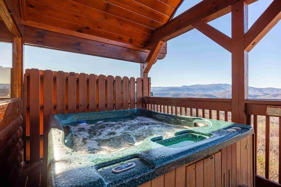 Unwind in the private hot tub while soaking in serene mountain views.
