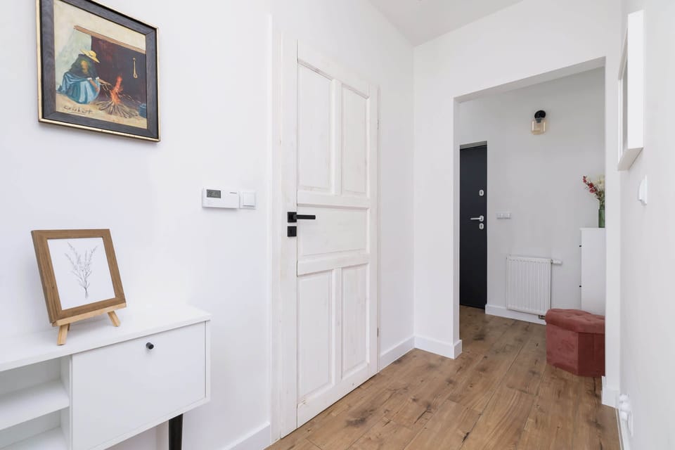 Bright and airy hallway with light wood flooring and minimalist décor.
