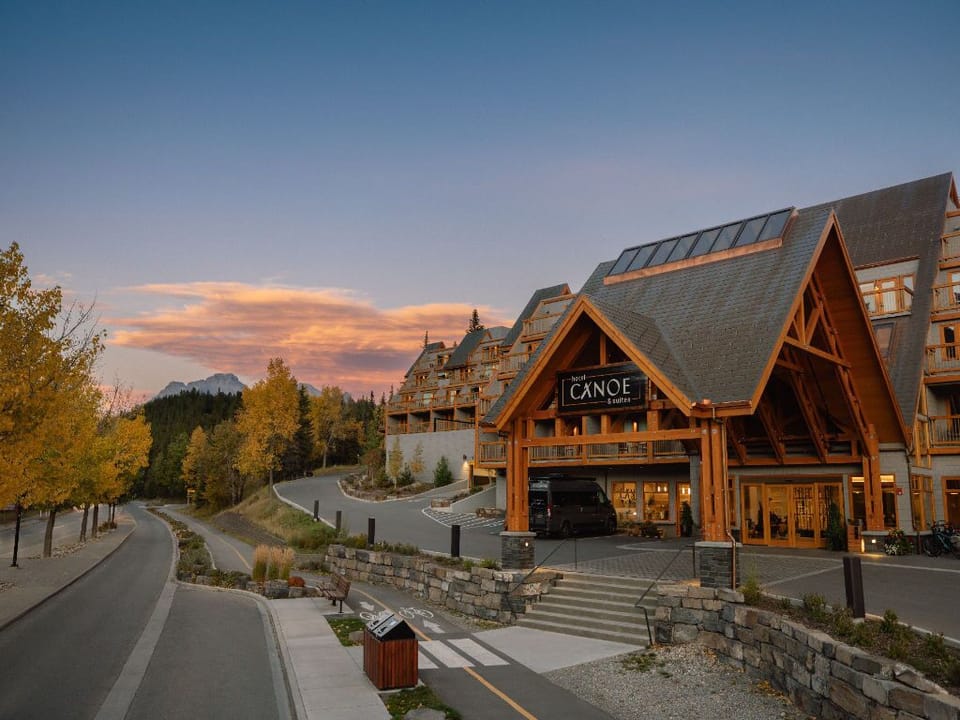 Admire the stunning architecture and warm welcome of Hotel Canoe and Suites, nestled amidst breathtaking surroundings.