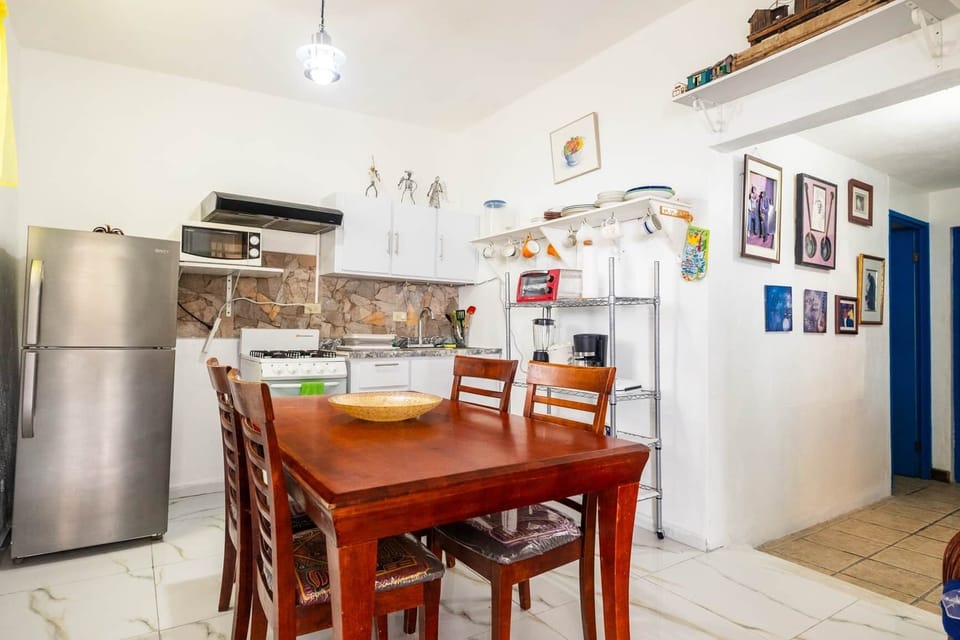 Fully equipped kitchen with fridge, stove, microwave and smaller appliances.