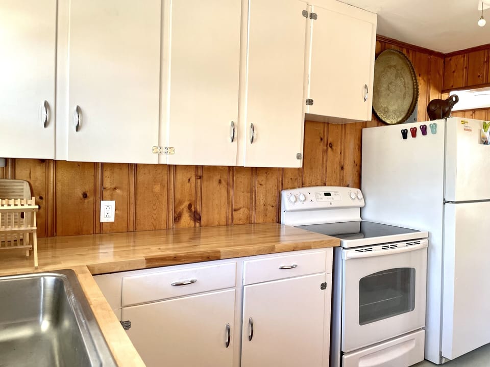 Kitchen is small but has all necessities. Stove/disposal/ fridge/kuerig