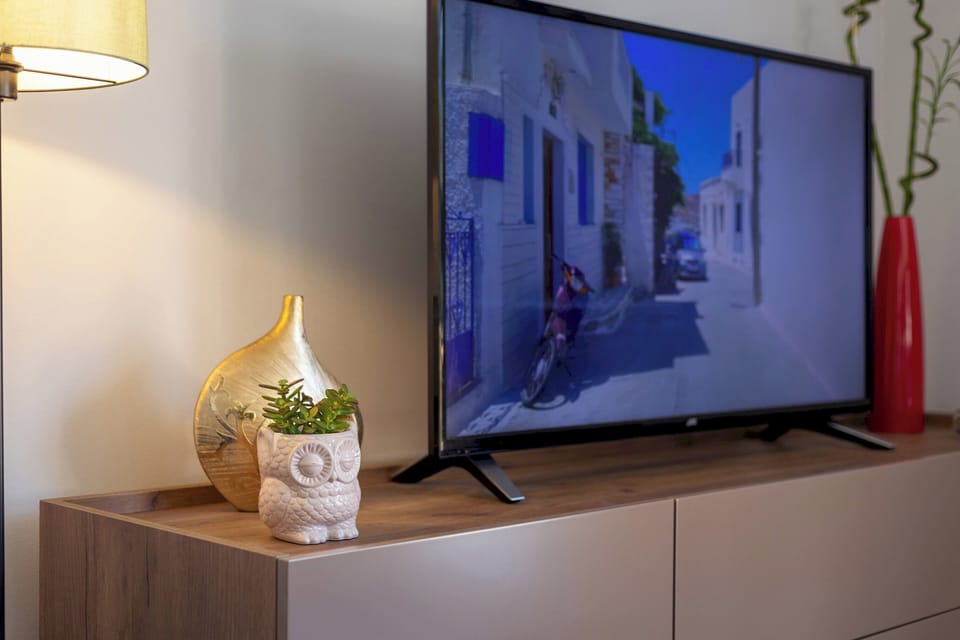 "Movie nights just got better with our sleek 50 inch TV - the ultimate way to unwind after a day of exploring the island!"