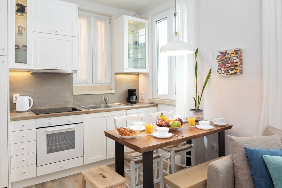 "Prepare delicious meals in our fully equipped kitchen, complete with a dining table for four."