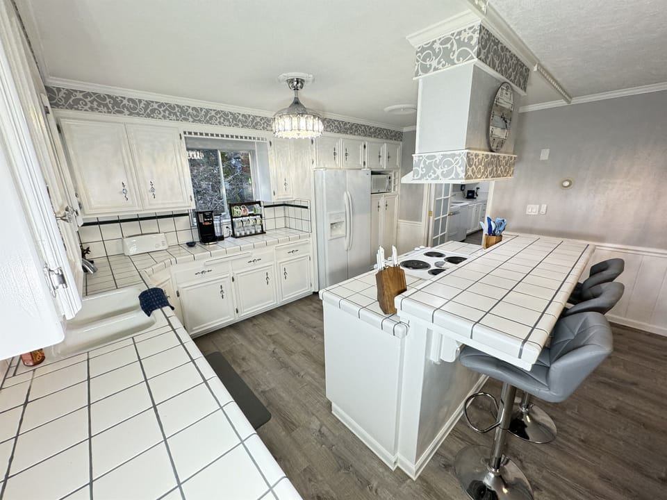 Open, airy kitchen with island for great family conversations.