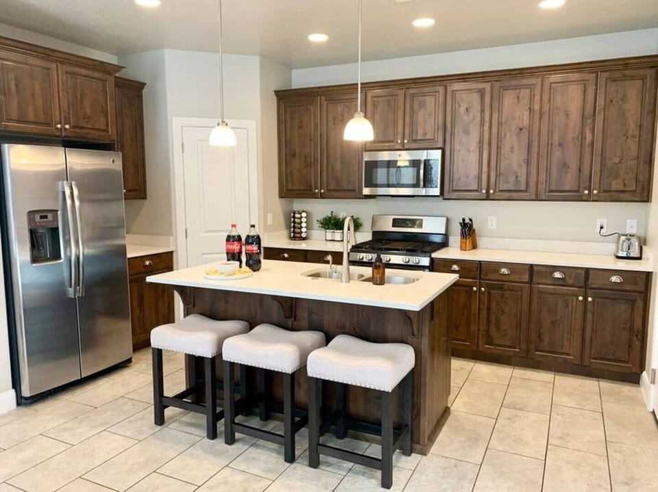 The kitchen is fully stocked with everything you may need- dishes, small appliances, pots, and pans. There is seating for 3 at the bar. 