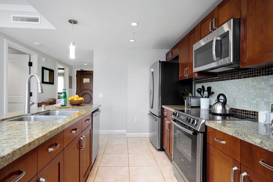 Spacious kitchen with granite countertops and sleek stainless steel appliances.