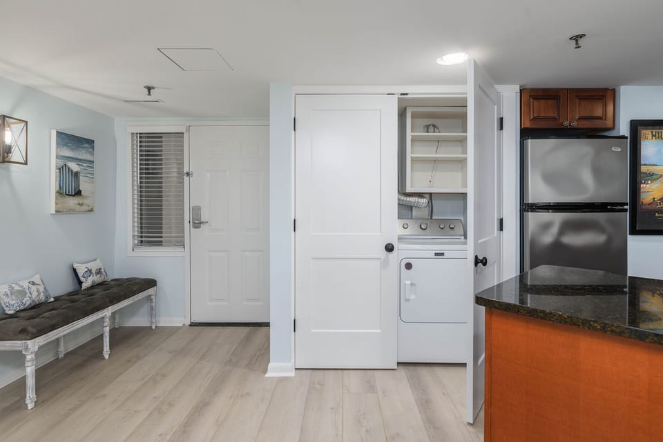 Front door entrance with kitchen and washer/dryer