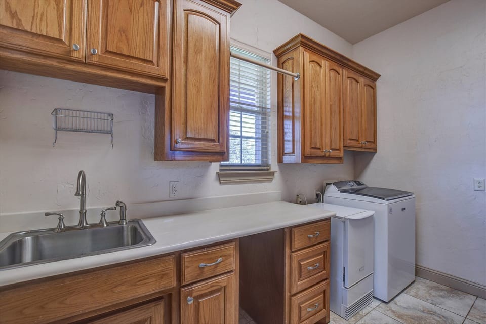Main House Laundry Room with Washer, Dryer, Ice Maker, and Extra Upright Freezer
