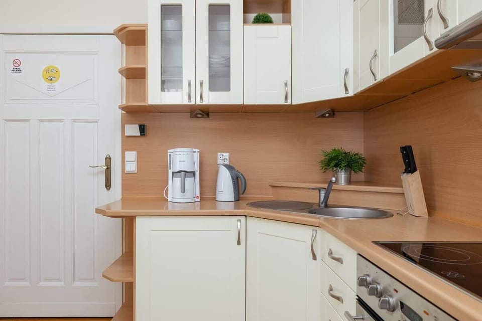 A well-equipped kitchen with wooden cabinets, a built-in oven, and a gas stove. The functional layout makes meal preparation easy and enjoyable.