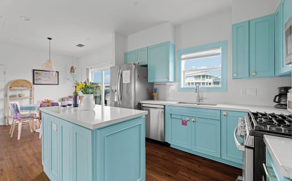 Kitchen Island — Turquoise Cabinets with Open Dining & Living Areas