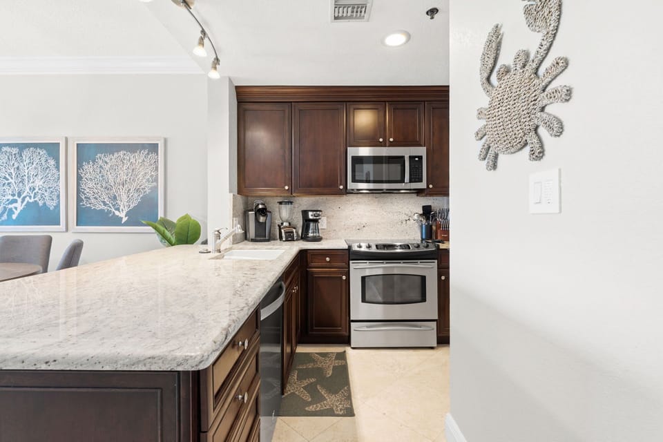 Spacious kitchen with bar stools and seamless Gulf-front living.