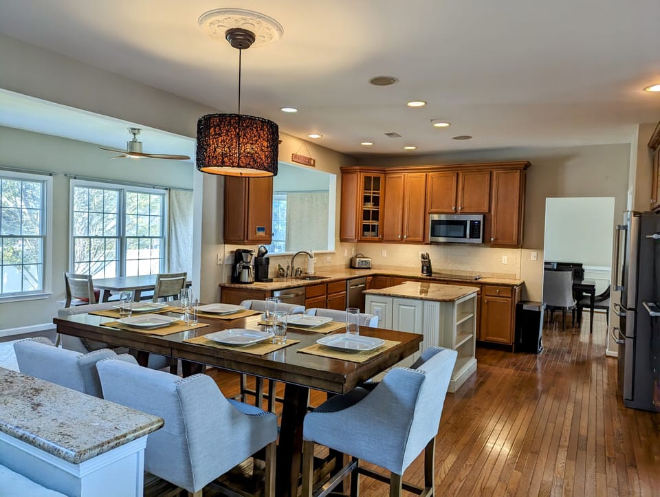 38353 Virginia Drive - Bethany Lakes - dining and kitchen - This angle showcases the transition from the sunny morning room to the formal dining and gourmet kitchen, emphasizing the home's spacious and airy layout.