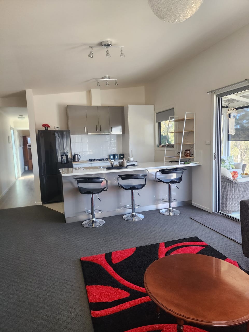 Open plan Loungeroom kitchen. Oven, Microwave,  Tea, Coffee, sugar and condimens