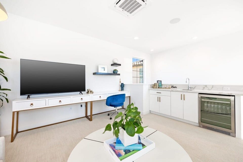 Loft area with a flat screen and laptop-friendly workspace.