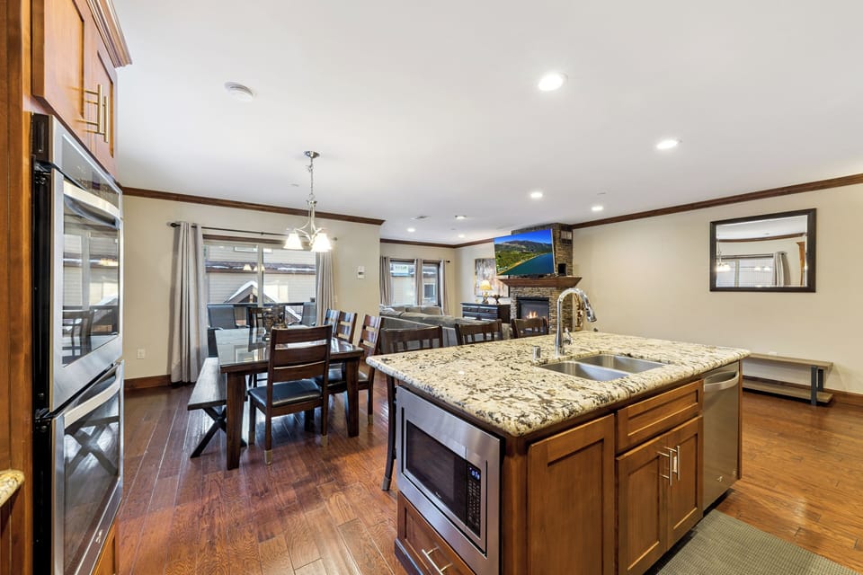 Your gourmet kitchen flows seamlessly into the cozy living area, where granite countertops and premium appliances make cooking a joy while staying connected to family.