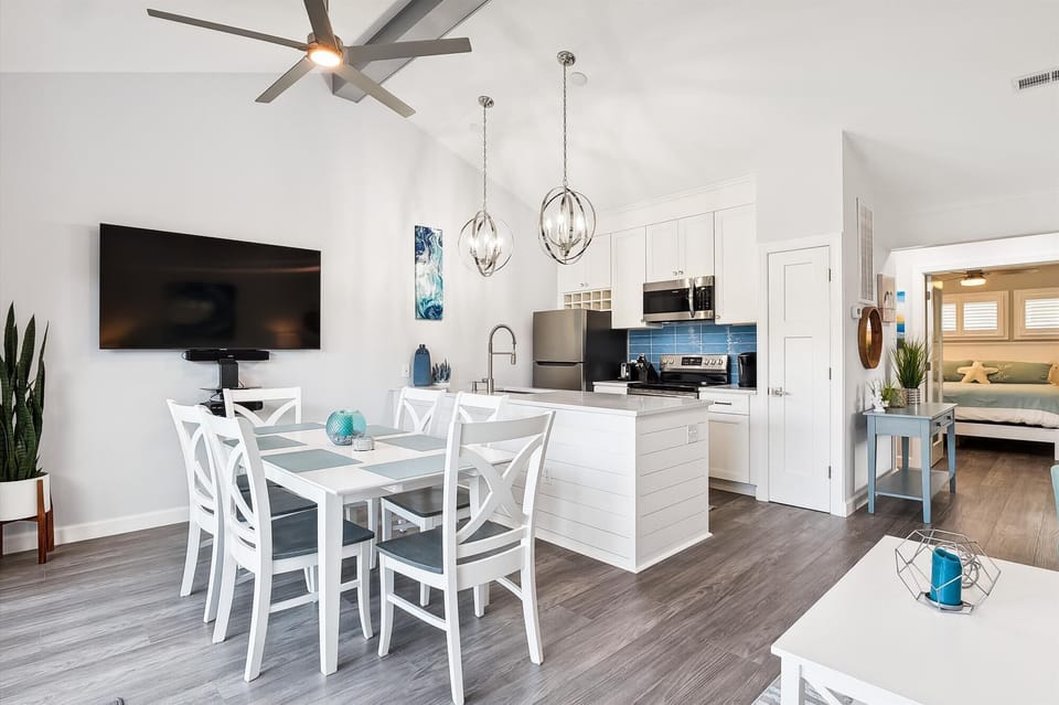 Relax in your open-concept retreat, where a bright kitchen flows into cozy dining and living spaces, all touched by coastal charm and modern comfort.