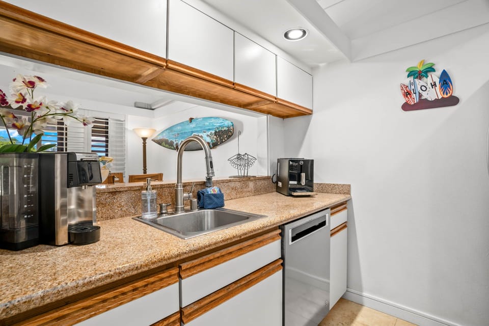 Bright kitchenette with granite counters, espresso machine, and dishwasher—perfect for easy stays!!!