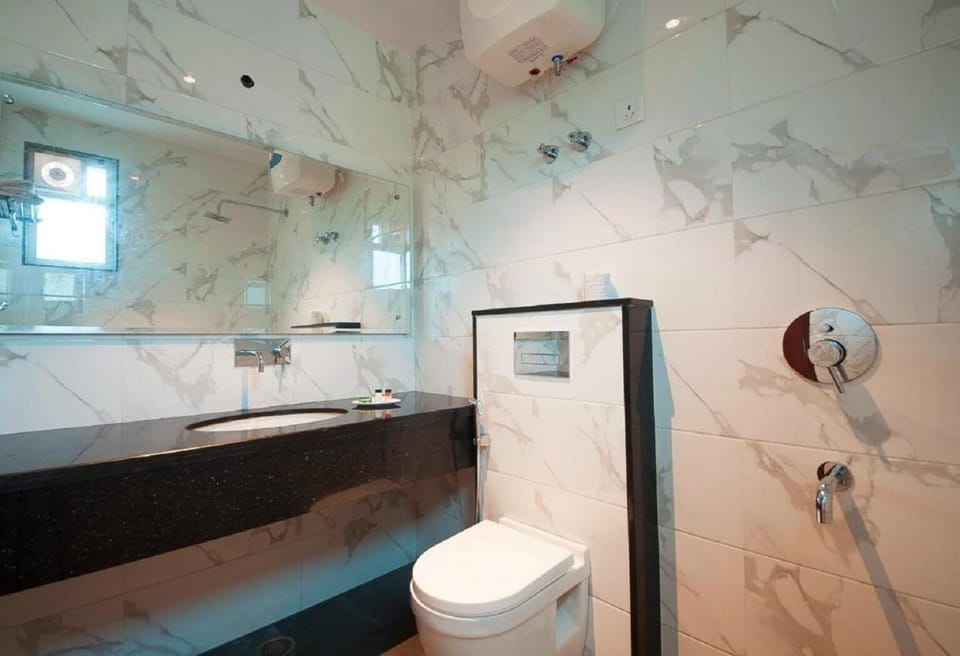 Shower, designer toiletries, slippers, towels
