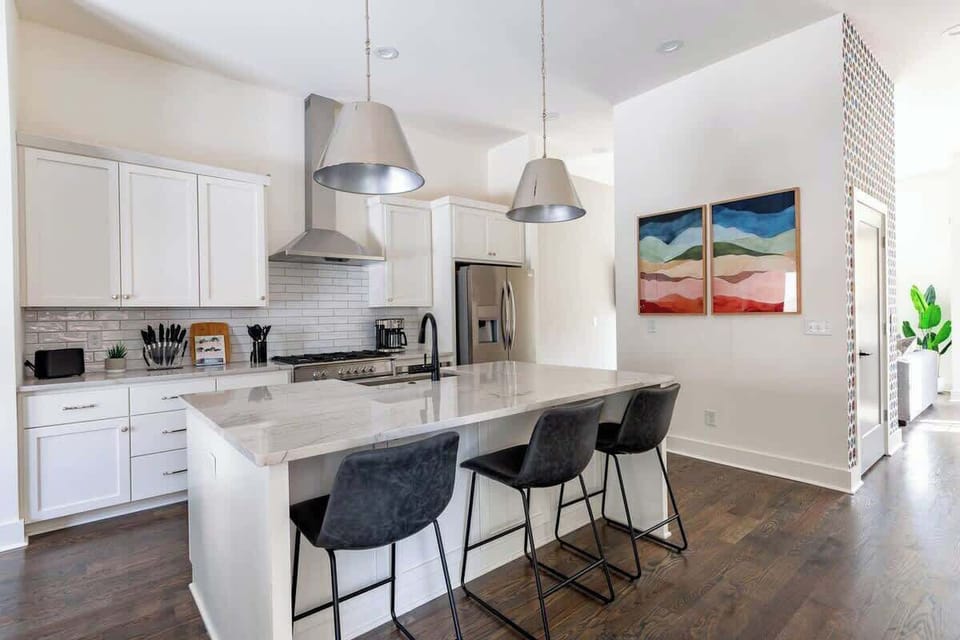 Luxe all-white kitchen, island counter for cooking or coffee moments