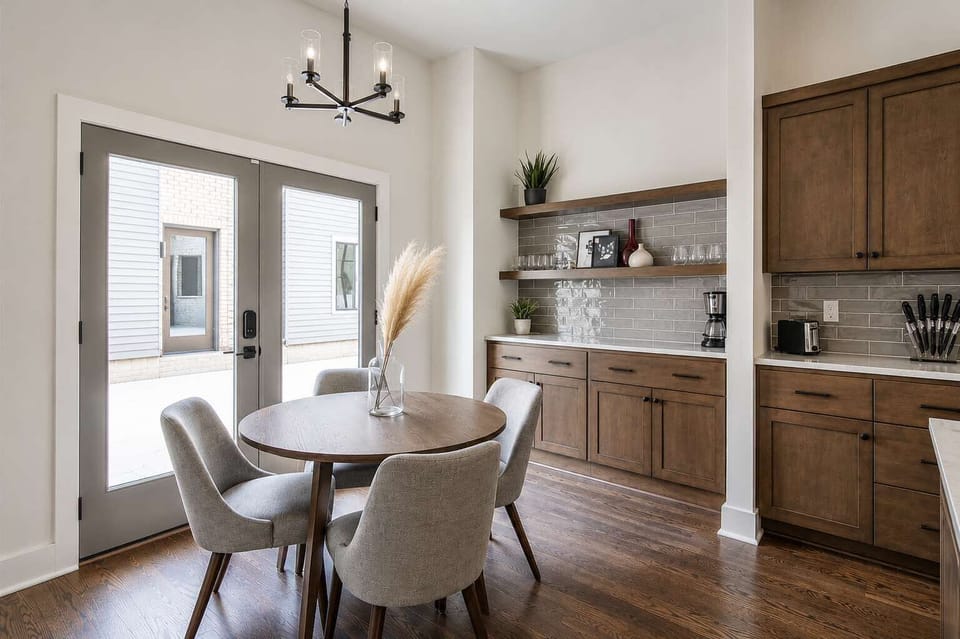 Cozy dining space with 4-seat round table and wet bar.