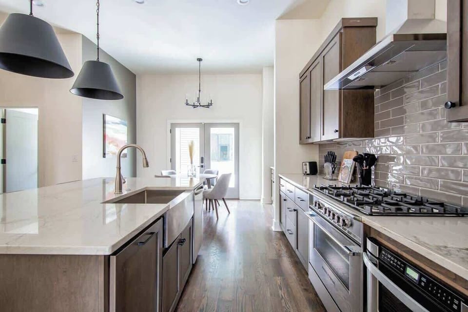 Fully equipped kitchen with warm wood cabinets and island counter.