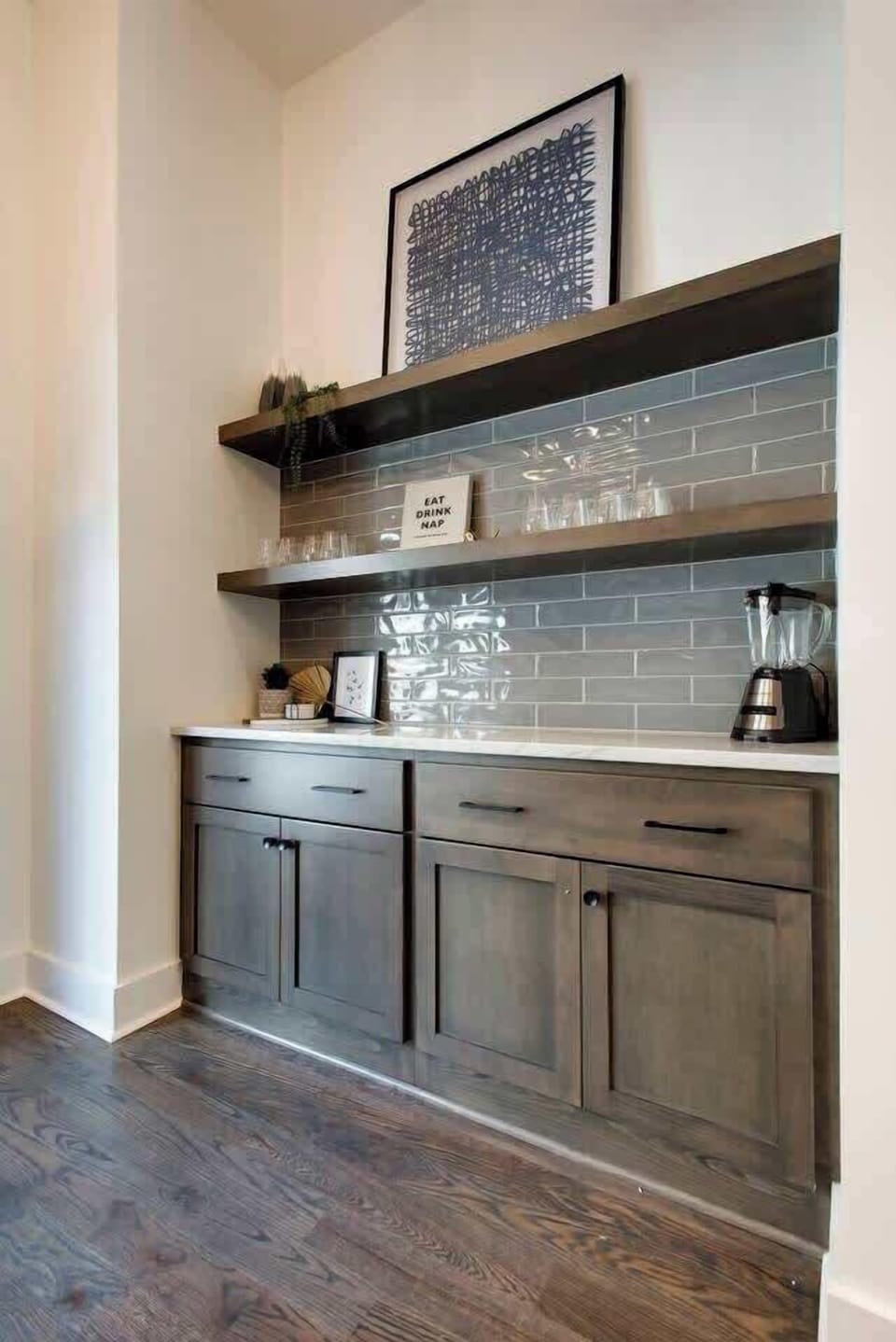 Wet bar highlighted by deep brown cabinet tones