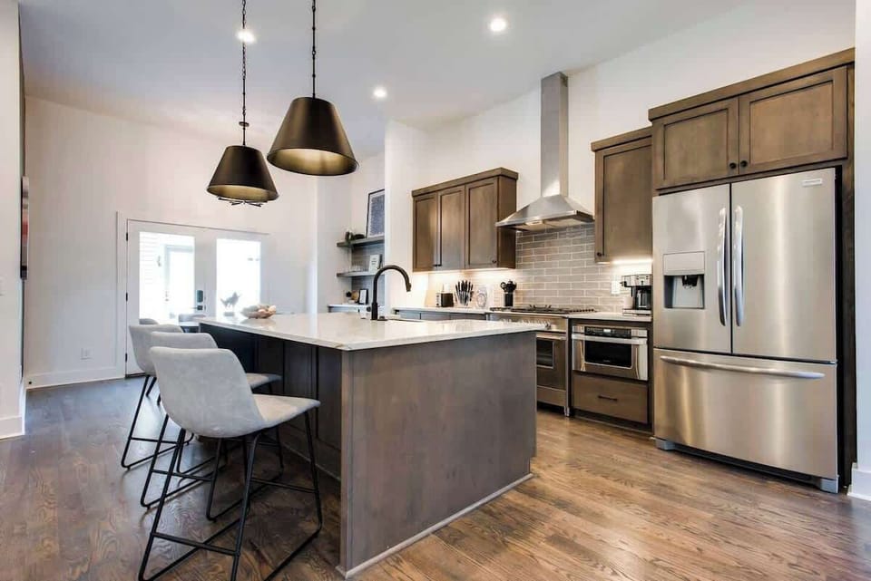 A picture-perfect kitchen with stainless steel appliances and beautiful wooden cabinets.