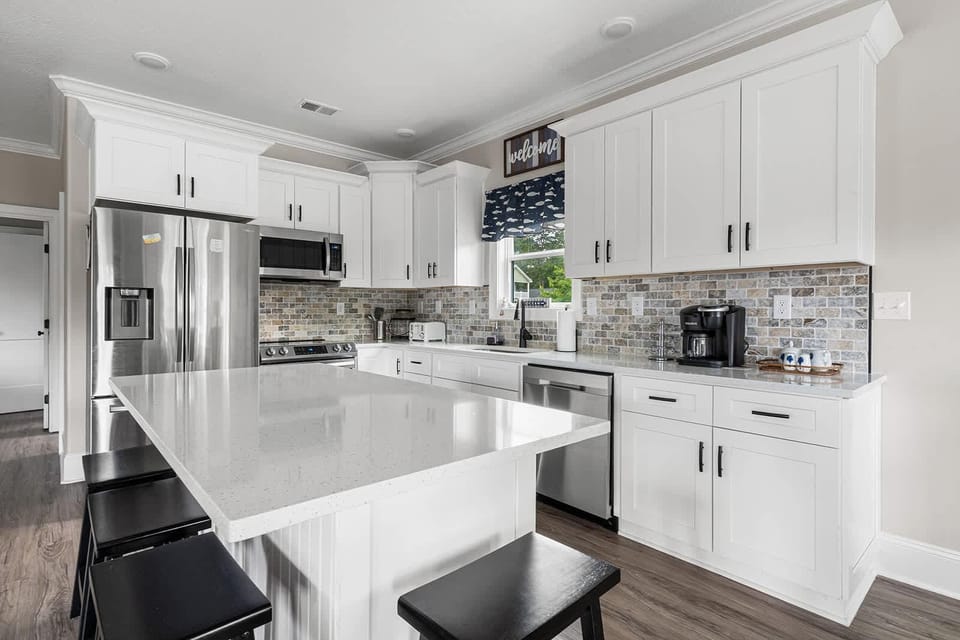 Bright, modern kitchen with sleek countertops and stainless steel appliances