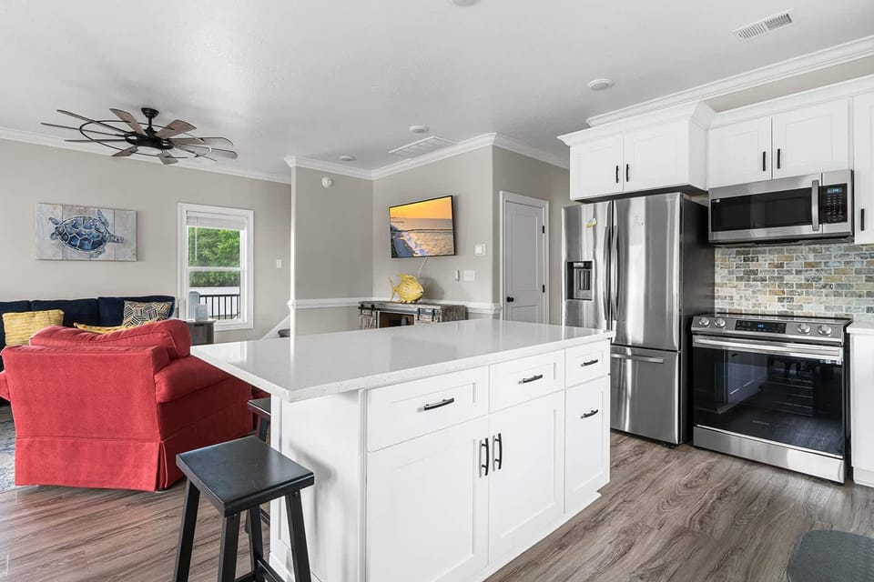 Bright, open kitchen with modern appliances and cozy living area