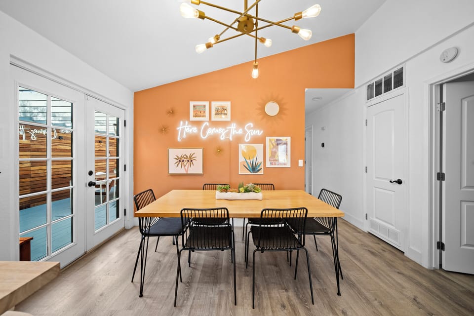 Dining room with desert themed neon-sign accent wall