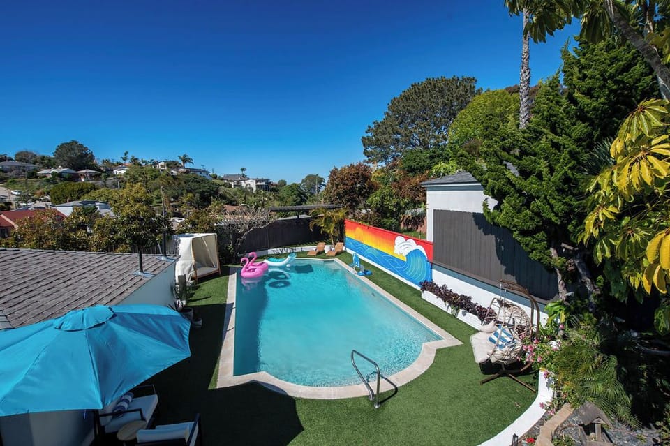 Spacious backyard featuring a private pool, seating, and room to relax.