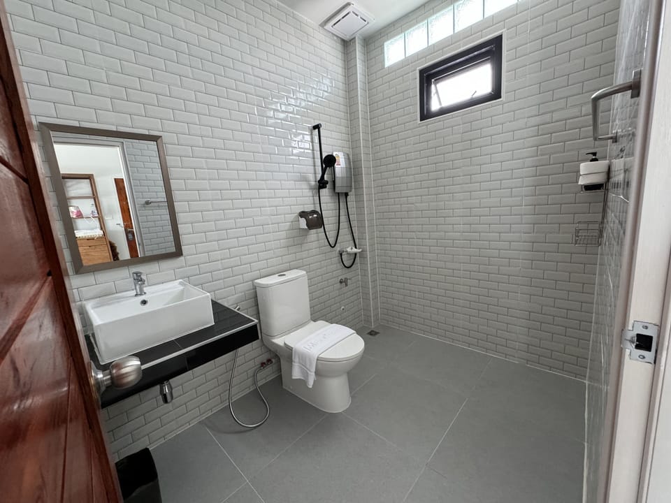 Family Room, Multiple Beds, Lanai | Bathroom | Slippers, towels, soap, shampoo