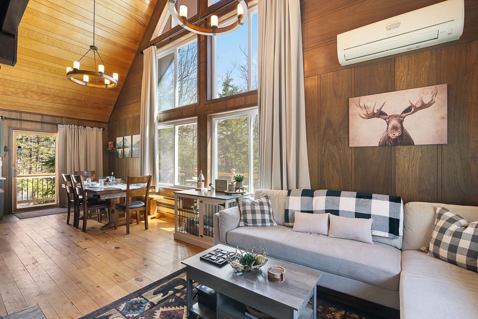 Main Level Living and Dining Rooms with beautiful 14' high windows overlooking the trees.
