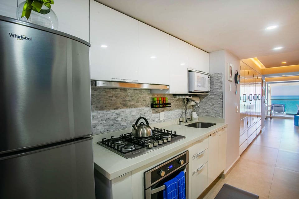 Kitchen amenities include a full-size fridge, stove, oven and microwave
