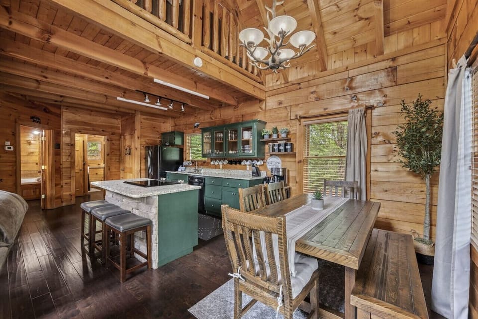 The dining area features a large, beautifully crafted table located right off the kitchen, making it the perfect spot for family meals and holiday feasts.