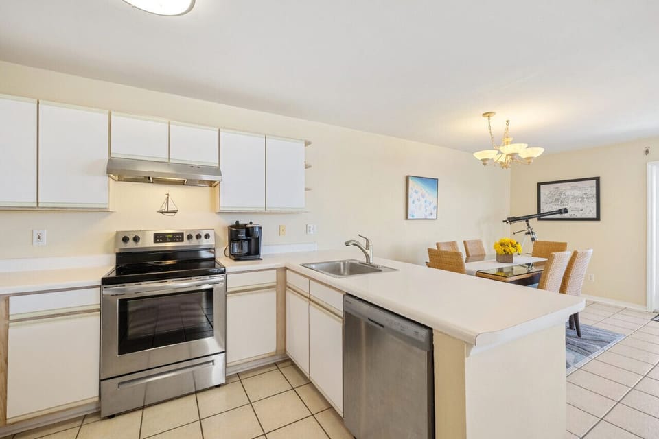 Kitchen with electric stove, drip coffee and dishwasher