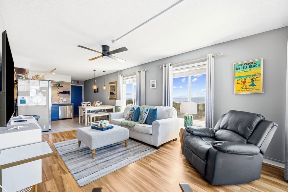 Bright coastal living room with water views and open dining space