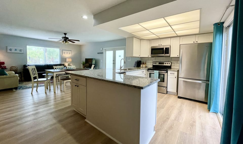 The boundaries between cooking, dining, and lounging seamlessly dissolve.