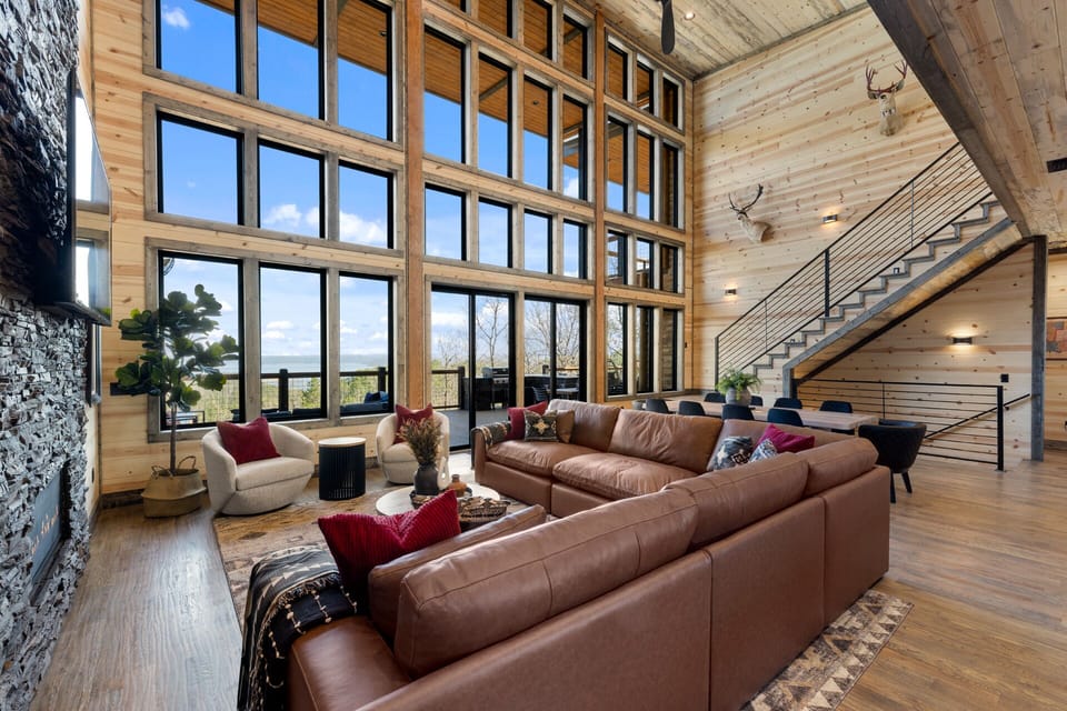 Huge sectional, giant window wall allowing lake & forest views to pour in