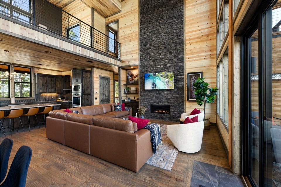 Incredible living area w/soaring ceiling, 70” Smart TV & huge leather sectional