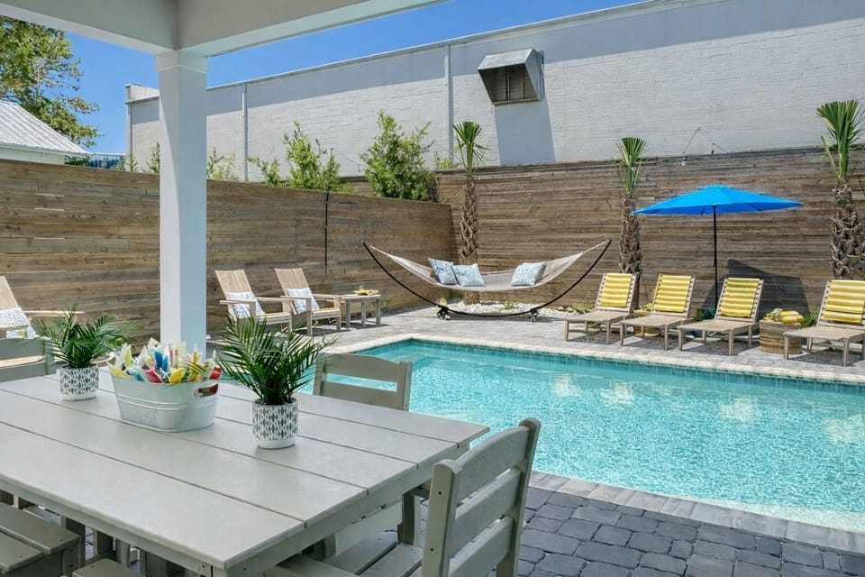 Your private poolside escape with a cozy hammock and shaded outdoor dining.