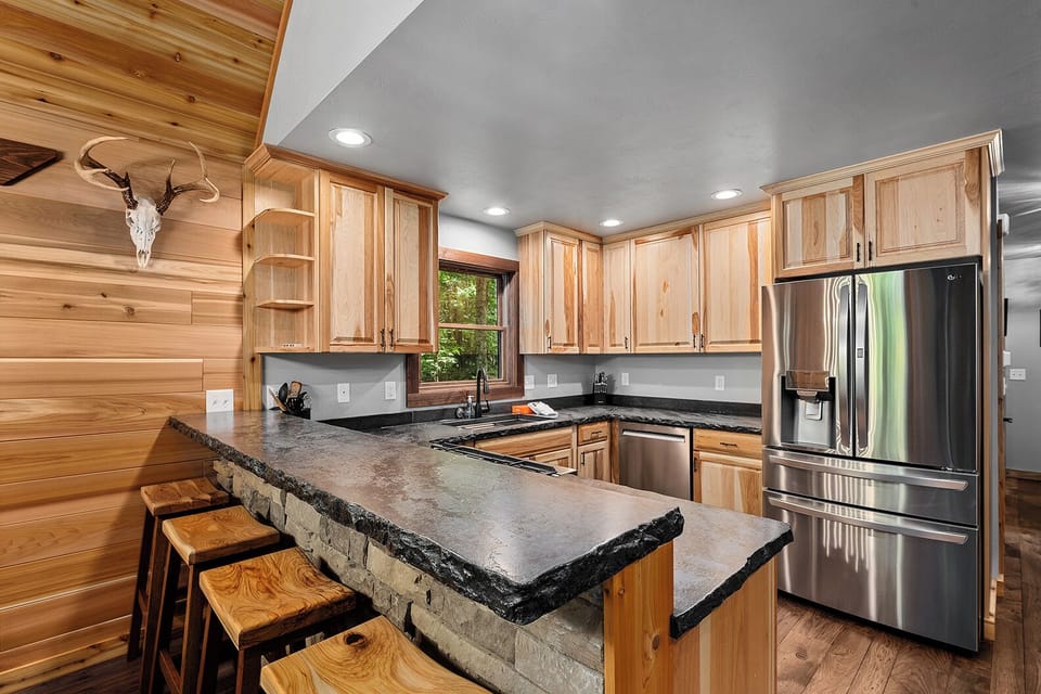 Additional Kitchen bar top dining.  Oversized refrigerator to hold all your supplies.  Extra refrigerator in the garage (not pictured).