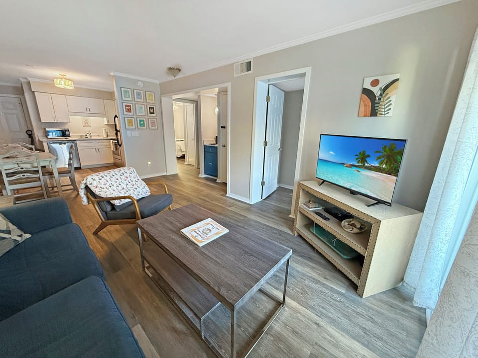Bright open-plan living with comfy seating, TV with cable.